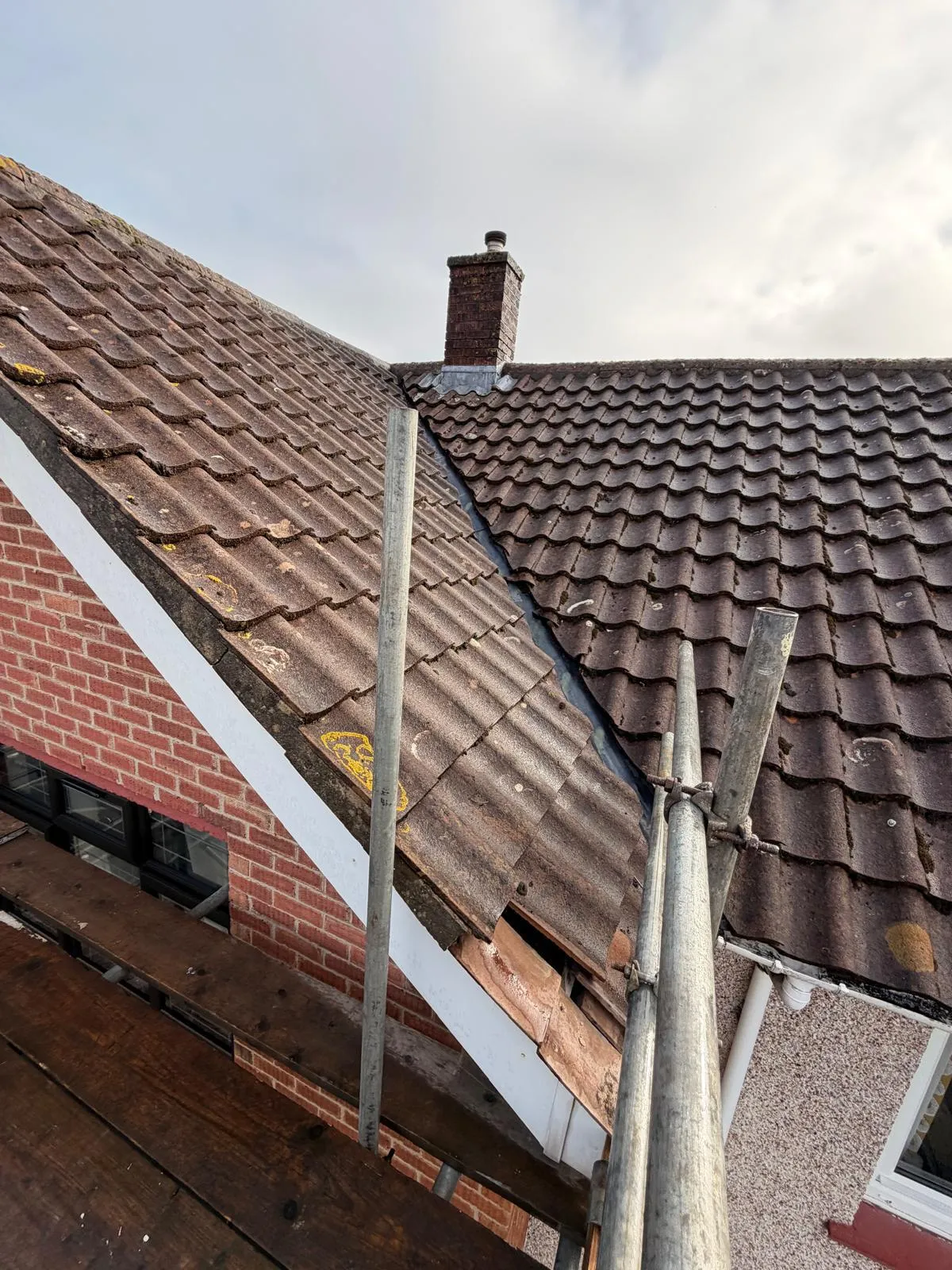 Old tiled roof with a damaged verge needing repair
