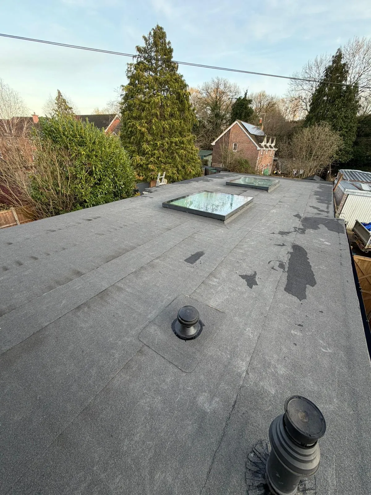 Finished felt flat roof with rooflights and vents