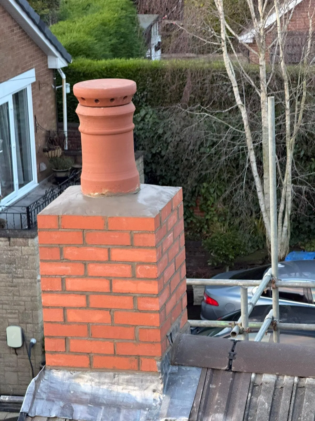 Rebuilt brick chimney with a new terracotta pot